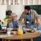 Group of cheerful seniors enjoying breakfast in nursing home care center